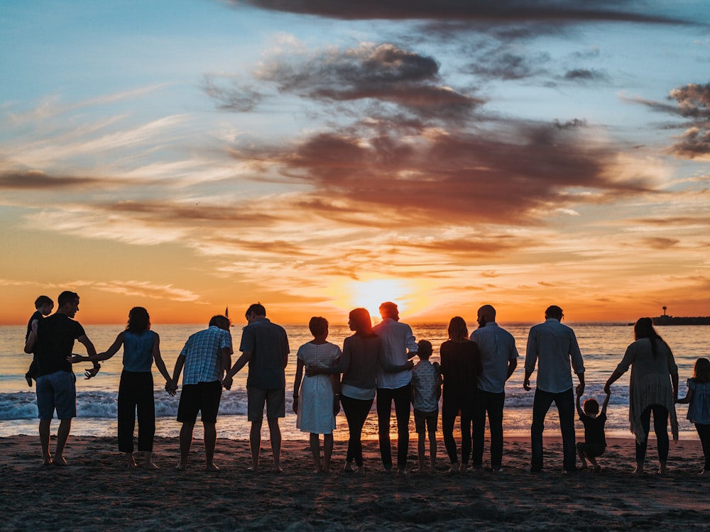 People standing together at sunset, hand in hand